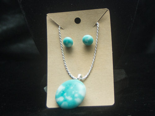 turquoise colored frit mixed amongst white fruit create this stunning necklace and earring pair.   all findings are heckle free and the necklace is 20" of sterling silver.   the pendant measures approximately 1".   This set looks amazing on!